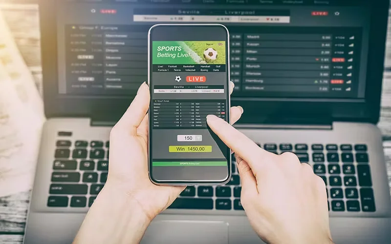 Ardent Bangladeshi fan monitoring live cricket data and statistics across multiple digital displays.